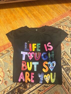Woman’s B lack Tee — "Life Is Tough But So Are You" Multicolor Graphic
